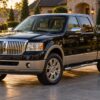 Black Lincoln Mark LT luxury pickup truck parked on a paved driveway with chrome grille and wheels